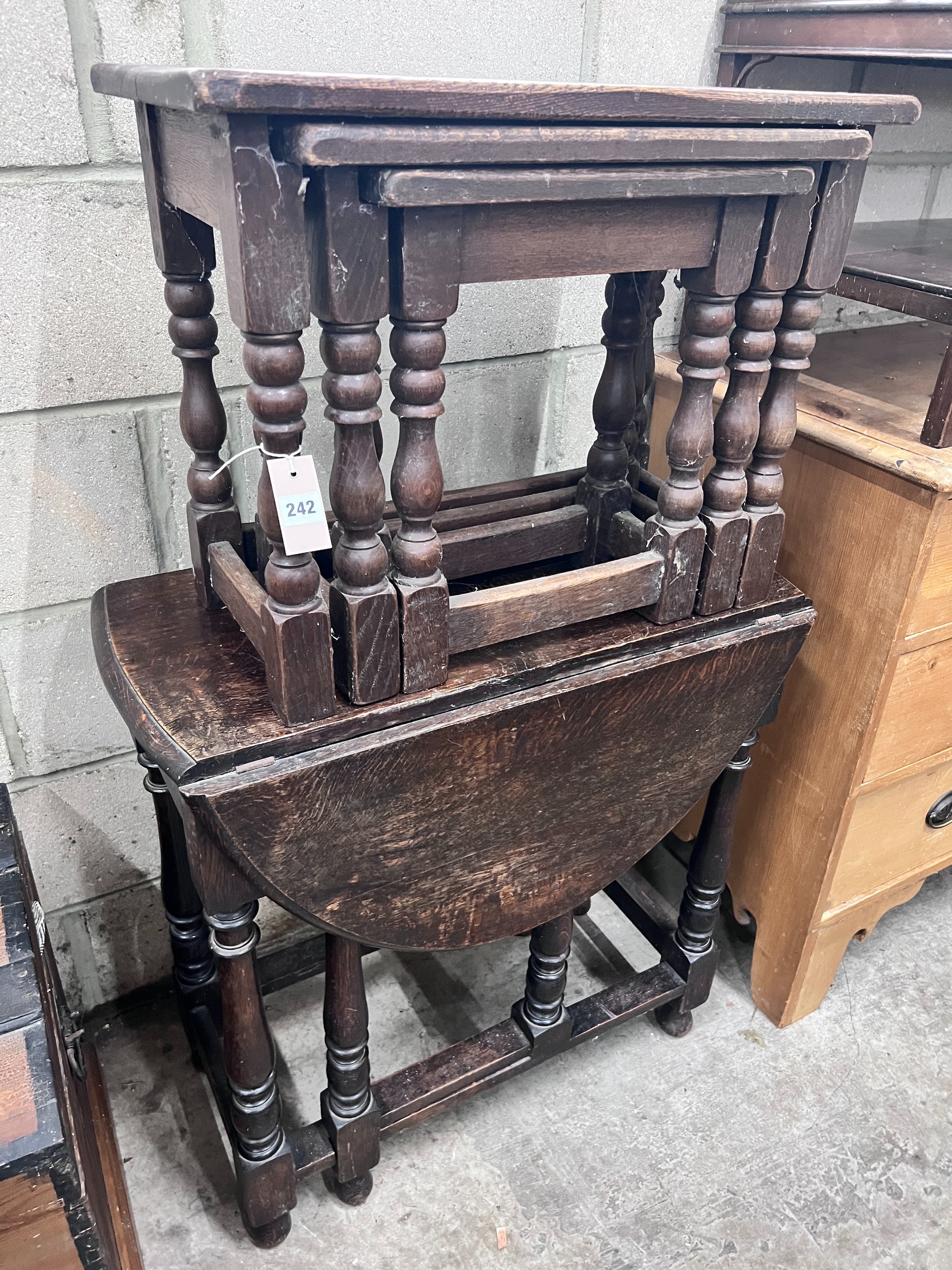 An 18th century style oak gateleg table, length 73cm, depth, 103cm, height 77cm, a nest of three oak tables, a mahogany two tier gallery top table and a spinning chair *Please note the sale commences at 9am.